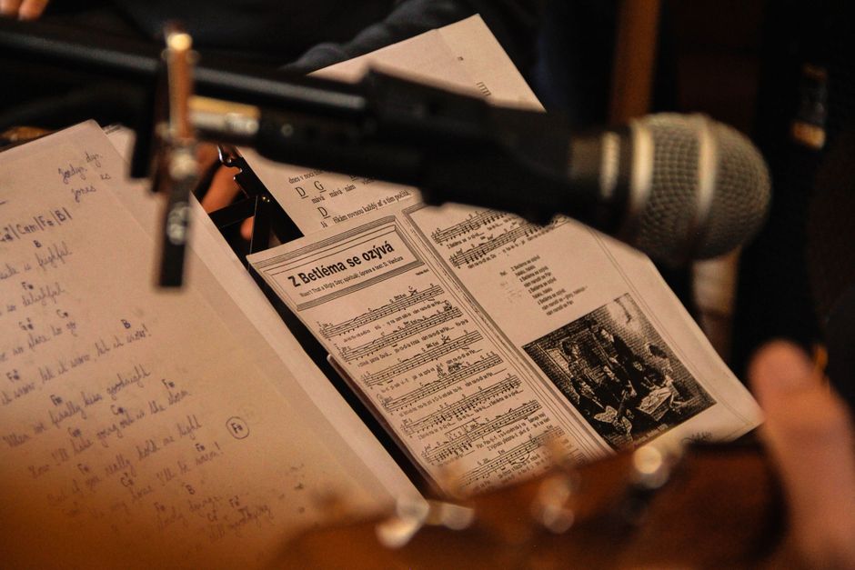 Close-up of sheet music with a microphone in a performance setting, capturing a musical moment.
